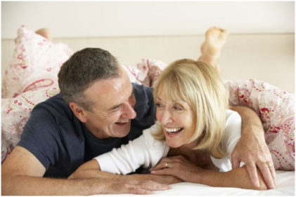 Mature Straight Couple In Bed Being Playful Which Helps With Relationship Intimacy