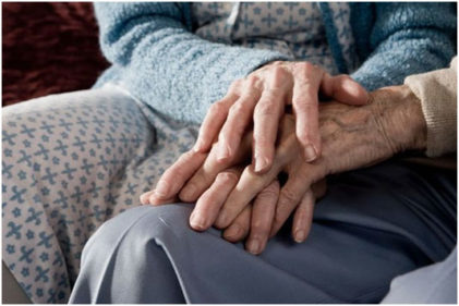 Elderly Couple Experience Intimacy By Holding Hands On Couch